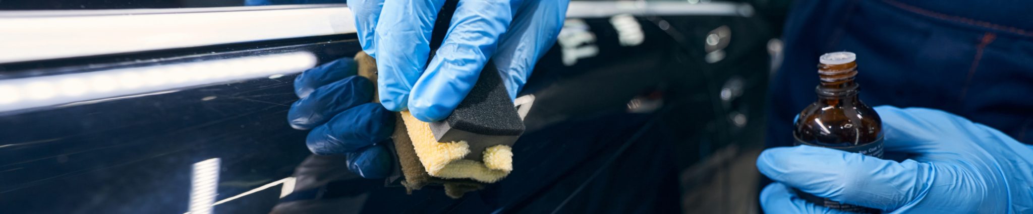 Professional ceramic coating application on a blue vehicle