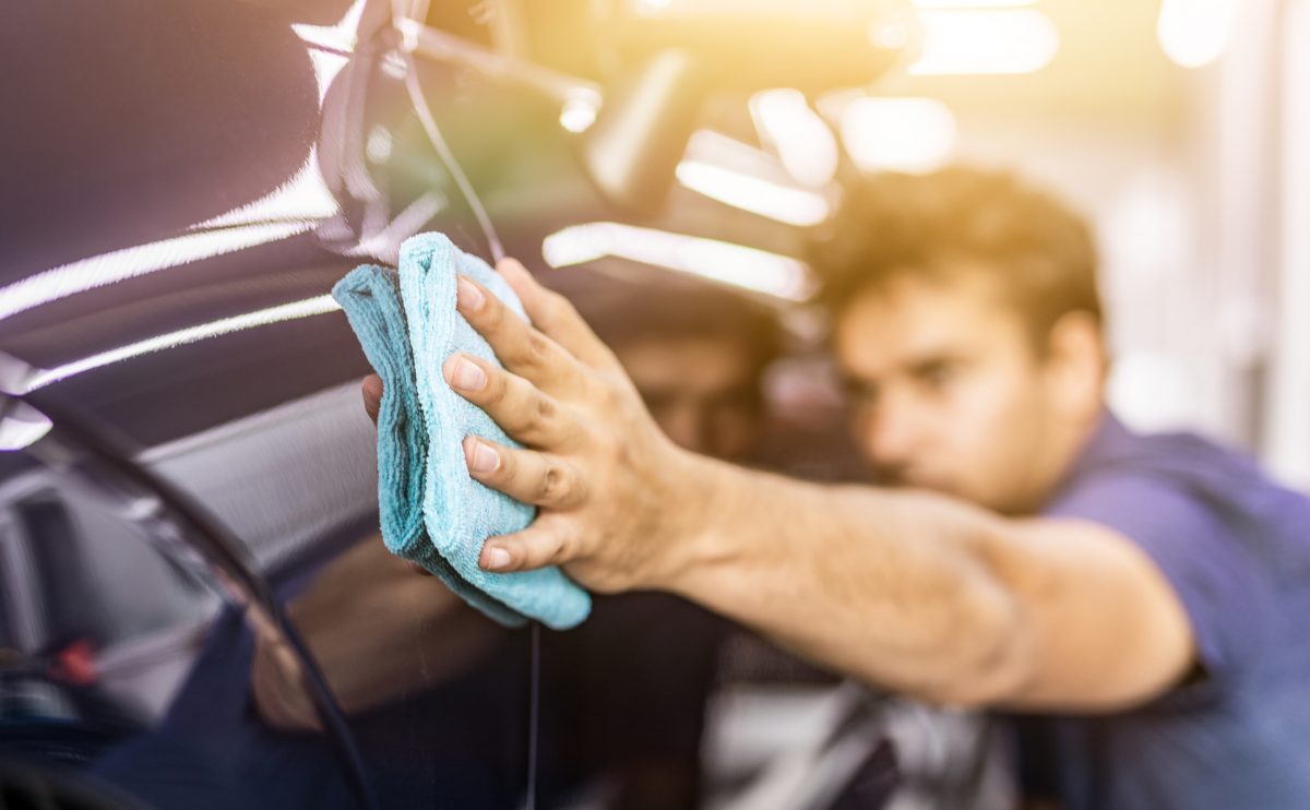 Man cleaning his ceramic coating with a microfiber towel so it stays effective
