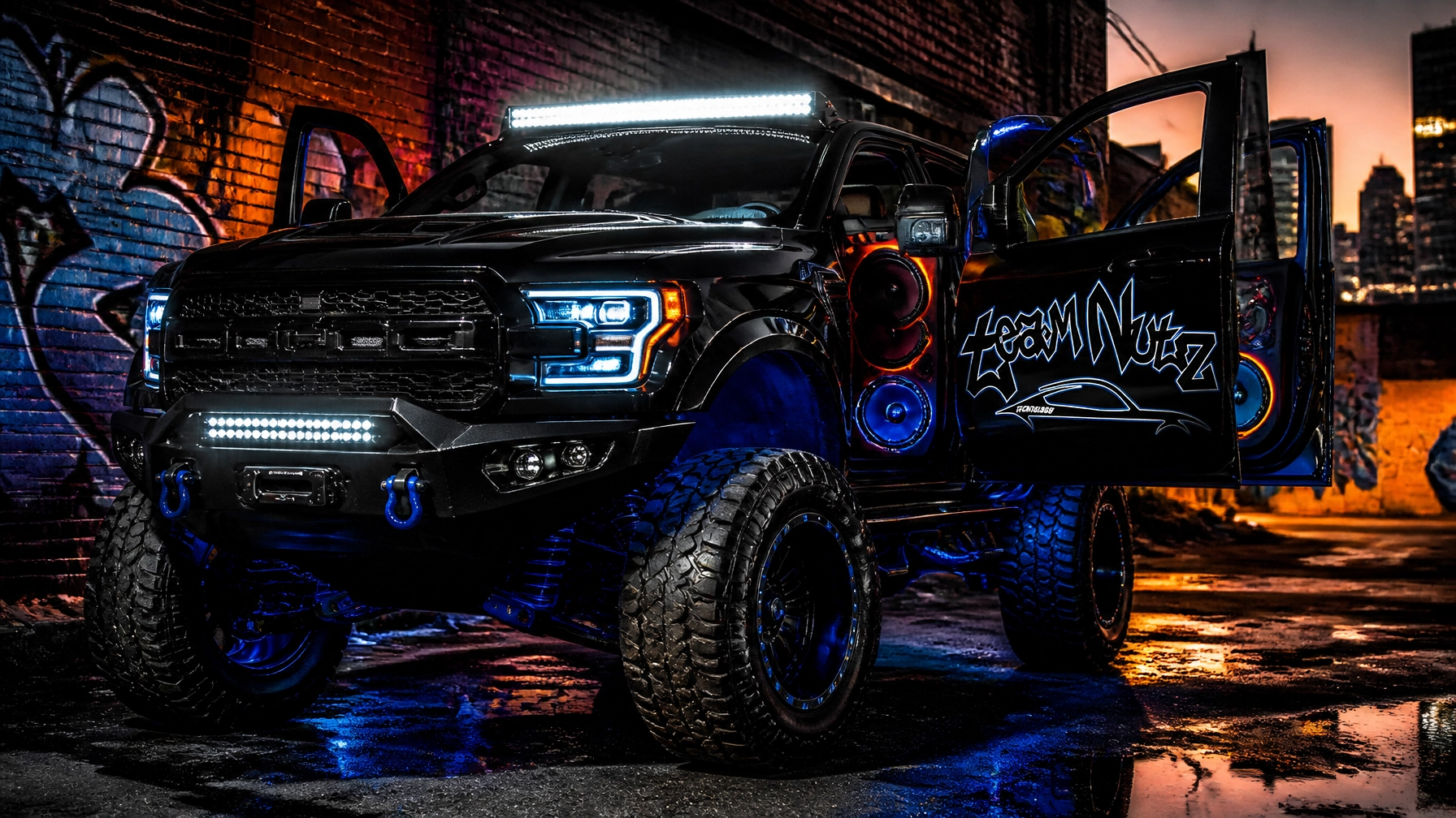 Black lifted pickup truck with open doors, neon blue lights and oversized wheels in an urban graffiti alley at dusk/foggy night.