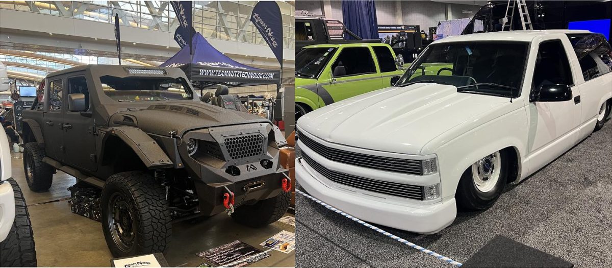 Side-by-side: on the left a matte black armored off-road SUV with large tires and rugged bumper at an indoor show; on the right a white customized lowered pickup with a wide grille and shaved sides, also at the show.